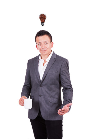 Smiling businessman holding coffee mug, coffee bulb over his headの写真素材