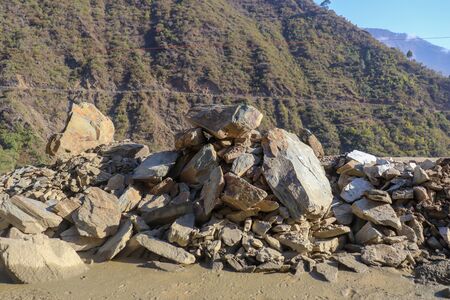 Broken stone or rubble stone in the road slide  with sunriseの写真素材