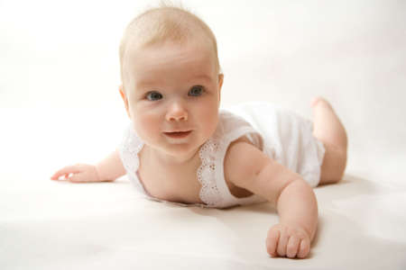 Child, baby on a bed.の写真素材