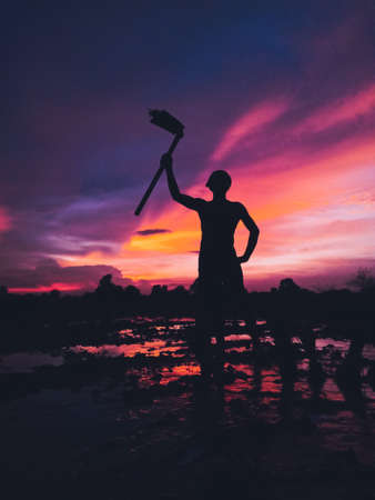Silhouette of a man at sunset.の写真素材