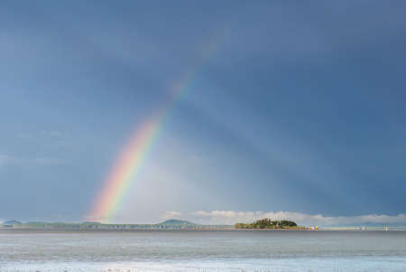 Colorful rainbow over small island, Thailandの写真素材