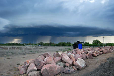 landscape of cultivate land with dark cloudsの写真素材