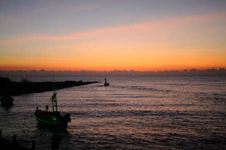 A crescent moon over the seaの写真素材