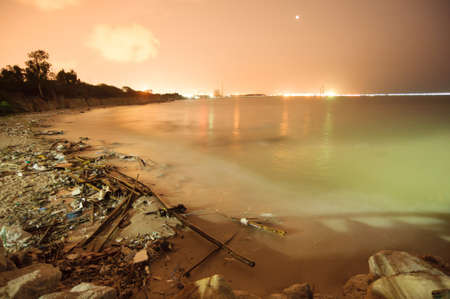 garbage on the beach near the industryの写真素材