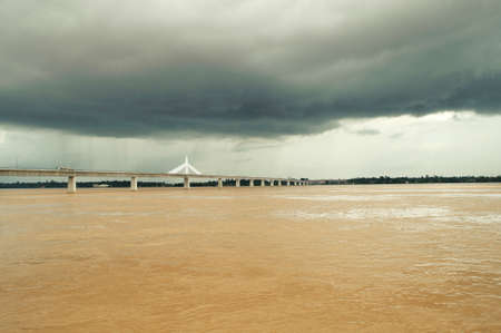 Storm clouds over Thai-Lao Bridge, Mukdahan, Thailandの写真素材