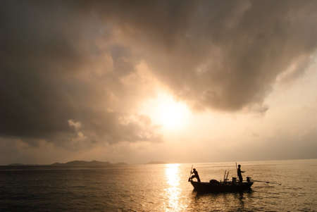 fisherman on boat in the sunrise at Koh Chang   Thailandの写真素材