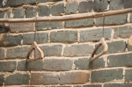 The wooden hanger hangs on a brick wall.の写真素材