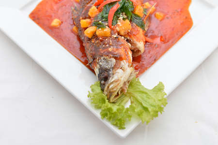 Fried snapper with chili sauce on the plateの写真素材