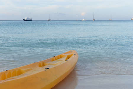Paddle boats on white sandy beach and blue seaの写真素材