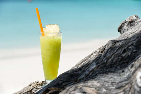 Fresh fruit cocktail juice on the beachの写真素材