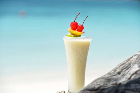Milk cocktail on wood at beach - vacation background