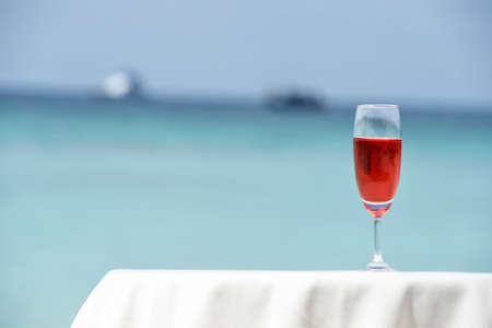 cocktail glass kept on sea beachの写真素材