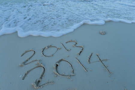 inscription 2014 on sea sand beach