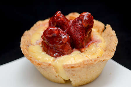 close-up of a tiny tart with strawberry on top
