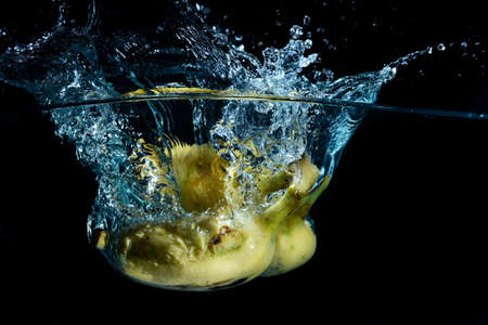 bananas being cleaned in a bowl of waterの写真素材