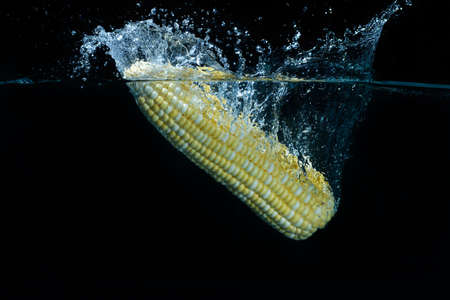 There was a fresh yellow corn drop into water