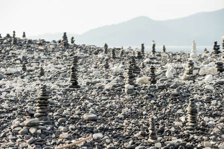 stacked stones on a background of beach and seaの写真素材