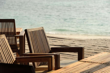 chairs and tables of tropical restaurant at ocean front