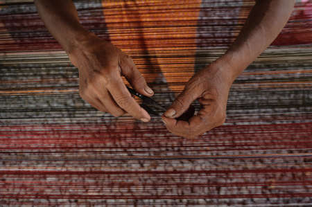 People are silk weaving in Thailandの写真素材