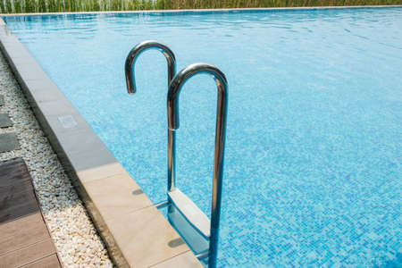 Swimming pool with stair at hotel close up