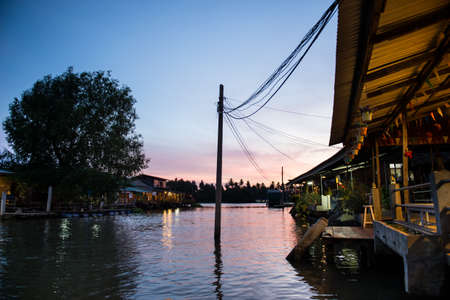 village near river in evening beautiful sunset at Amphawa, Thailandの写真素材