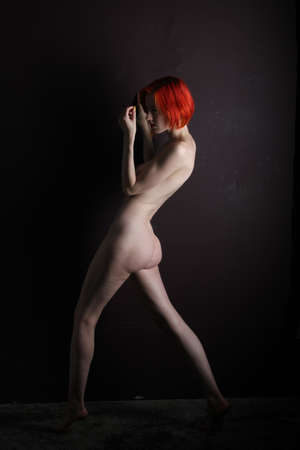 Photoshoot of a nude red headの写真素材
