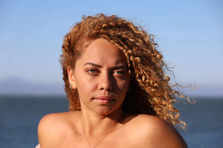 Photo of beautiful Brazilian lady on the beachの写真素材