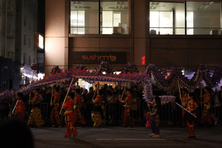 2-24-2024: San Francisco, California: Chinese New Year Parade, Performers with a dragon floatのeditorial素材
