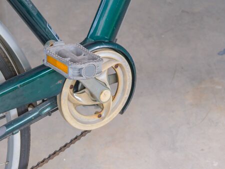 Bike pedal of green bicycle.