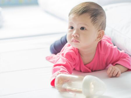 Asian baby crawling on the bed.の写真素材