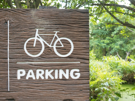 Wooden bicycle sign in the park.の写真素材
