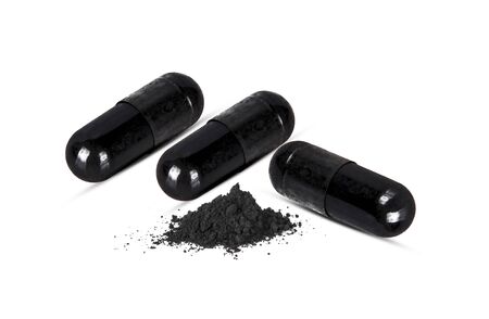 Charcoal capsules isolated on whiteの写真素材