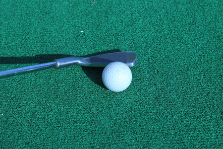 Wood and golf balls on the green grass