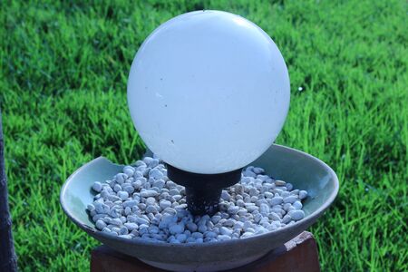 White Lantern in a park with green grass backgroundの写真素材