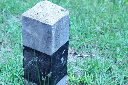 Black and white traffic pole beside a rural roadの写真素材