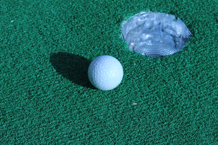 Wood and golf balls on the green grassの写真素材