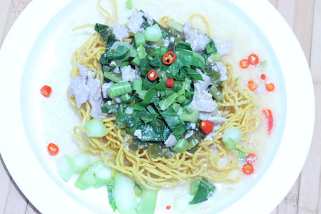 Kale noodles topped with pork and red pepperの写真素材