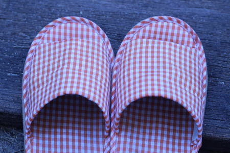 Shoes in the house on a wooden board in the gardenの写真素材