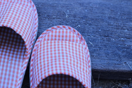 Shoes in the house on a wooden board in the gardenの写真素材