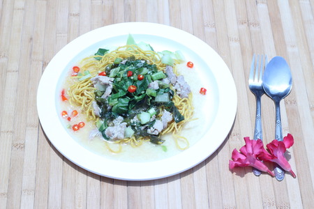 Kale noodles topped with pork and red pepperの写真素材