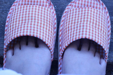 Shoes in the house on a wooden board in the gardenの写真素材