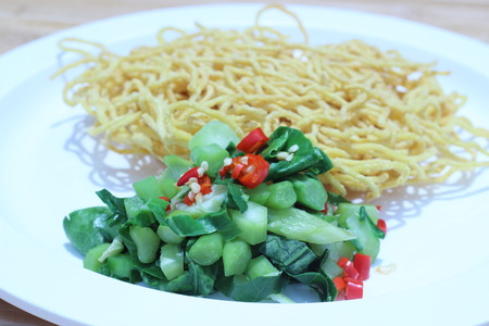 Kale noodles topped with pork and red pepperの写真素材
