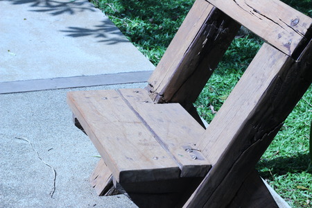 rown wooden bench placed in the backyardの写真素材