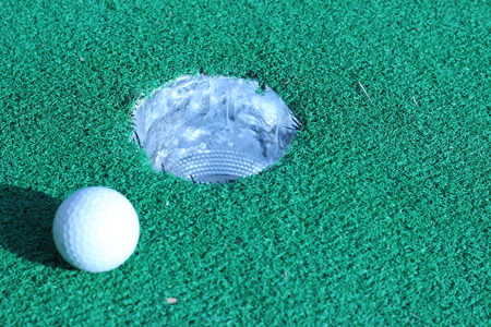 Wood and golf balls on the green grassの写真素材