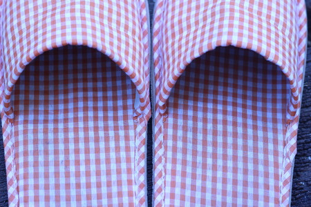 Shoes in the house on a wooden board in the gardenの写真素材