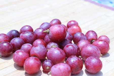 Purple grapes on brown background air densityの写真素材