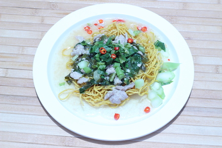 Kale noodles topped with pork and red pepperの写真素材