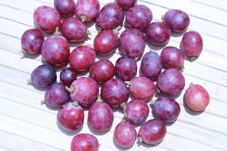 Purple grapes on brown background air densityの写真素材