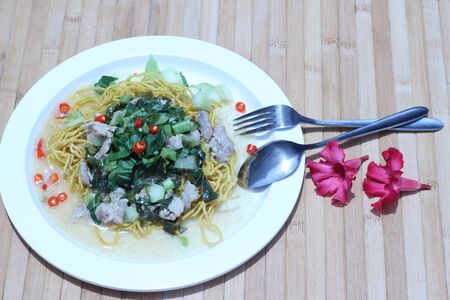 Kale noodles topped with pork and red pepperの写真素材