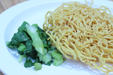 Kale noodles topped with pork and red pepperの写真素材